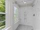 Beautiful shower with marble subway tile and seamless glass door at 5012 Silverdene St, Raleigh, NC 27616