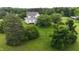 Aerial view of a sprawling backyard, surrounded by green grass, bushes, and mature trees at 526 Bob Rainey Trl, Burlington, NC 27217