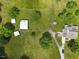 Sprawling property featuring a residence, barns, and outbuildings connected by a private driveway at 526 Bob Rainey Trl, Burlington, NC 27217