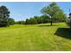 Expansive grassy backyard and green trees at 526 Bob Rainey Trl, Burlington, NC 27217