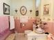 Bathroom featuring decorative floral wallpaper, sink and toilet at 526 Bob Rainey Trl, Burlington, NC 27217