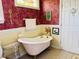 Unique bathroom with a clawfoot tub, vintage fixtures, and decorative wallpaper with plenty of space at 526 Bob Rainey Trl, Burlington, NC 27217