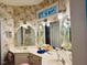 Elegant bathroom with floral wallpaper, dual sinks and ample lighting at 526 Bob Rainey Trl, Burlington, NC 27217