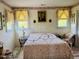 Cozy bedroom featuring a white iron bed frame, soft lighting, and charming vintage decor at 526 Bob Rainey Trl, Burlington, NC 27217