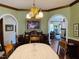 Charming dining room with hardwood floors, chandelier, vintage furniture and arched openings at 526 Bob Rainey Trl, Burlington, NC 27217