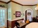 Traditional dining area with decorative wallpaper, lighting, and access to an adjacent room at 526 Bob Rainey Trl, Burlington, NC 27217