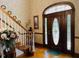Grand entryway featuring an arched door with leaded glass and beautiful staircase at 526 Bob Rainey Trl, Burlington, NC 27217