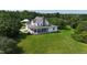 Charming two-story home with a welcoming wrap-around porch, surrounded by lush greenery and mature trees at 526 Bob Rainey Trl, Burlington, NC 27217