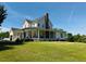 Expansive property featuring a well-maintained home with a long, inviting porch and lush green lawn at 526 Bob Rainey Trl, Burlington, NC 27217