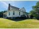 View of a farmhouse with a back porch, lawn and a combination of siding, brick, and stone at 526 Bob Rainey Trl, Burlington, NC 27217