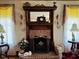 A fireplace with detailed woodwork, a mirror, and decor at 526 Bob Rainey Trl, Burlington, NC 27217