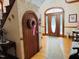 Grand foyer showcasing the home's distinctive door, hardwood floors and charming details at 526 Bob Rainey Trl, Burlington, NC 27217