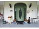 Detailed front door with decorative elements, potted flowers, and vintage accents, adding character to the entrance at 526 Bob Rainey Trl, Burlington, NC 27217