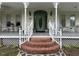 Charming entryway with decorative door, potted plants, and vintage decor, showcasing a welcoming exterior at 526 Bob Rainey Trl, Burlington, NC 27217