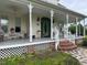 Welcoming front porch with detailed railings and lattice work, creating an inviting entrance to the home at 526 Bob Rainey Trl, Burlington, NC 27217