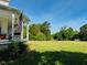 Charming home exterior featuring a large, well-maintained lawn and mature trees at 526 Bob Rainey Trl, Burlington, NC 27217