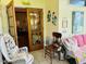 Cozy sitting area with wicker furniture and cottage decor in a sun-drenched hallway at 526 Bob Rainey Trl, Burlington, NC 27217