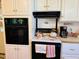 Traditional kitchen with black oven and white upper and lower cabinets at 526 Bob Rainey Trl, Burlington, NC 27217