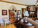 Comfortable living room featuring hardwood floors, a decorative cabinet, and a cozy seating area at 526 Bob Rainey Trl, Burlington, NC 27217