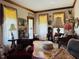 Living room featuring vintage furniture, decorative curtains, and classic decor at 526 Bob Rainey Trl, Burlington, NC 27217