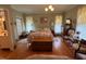 Comfortable main bedroom featuring natural light, vintage furniture, and hardwood floors at 526 Bob Rainey Trl, Burlington, NC 27217