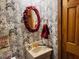 Unique powder room featuring distinctive wallpaper and vanity at 526 Bob Rainey Trl, Burlington, NC 27217