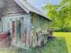 Exterior side view of shed on grassy lot shows open door at 526 Bob Rainey Trl, Burlington, NC 27217