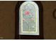 Arched stained glass window featuring delicate floral and bird designs at 526 Bob Rainey Trl, Burlington, NC 27217
