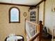 View of a decorative staircase with a chandelier and stained glass window at 526 Bob Rainey Trl, Burlington, NC 27217