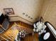 Overhead view of the staircase with floral wallpaper and a stylish chandelier at 526 Bob Rainey Trl, Burlington, NC 27217
