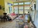 Bright sunroom with ample natural light, cozy seating, and charming decor, perfect for relaxing and entertaining at 526 Bob Rainey Trl, Burlington, NC 27217