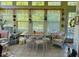 Bright sunroom with lots of natural light, a dining set, and comfortable seating at 526 Bob Rainey Trl, Burlington, NC 27217