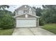 Charming two-story home with a stone accented garage and a well-maintained lawn at 6005 Namozine Ct, Raleigh, NC 27610