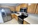 Kitchen features stainless steel appliances and light wood cabinetry at 6005 Namozine Ct, Raleigh, NC 27610