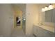 Bright bathroom featuring marble floors, frameless glass shower, and white vanity at 615 Sampson St, Raleigh, NC 27609