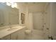 Bright bathroom features white vanity, tub-shower with tile surround, and neutral decor at 615 Sampson St, Raleigh, NC 27609