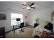 Bright bedroom with ceiling fan, cozy bed, and a work/desk area at 615 Sampson St, Raleigh, NC 27609