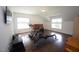 Spacious bonus room with wood floors, lots of natural light and exercise equipment at 615 Sampson St, Raleigh, NC 27609