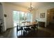 Bright dining room with hardwood floors, modern chandelier, and sliding doors leading to outdoor space at 615 Sampson St, Raleigh, NC 27609