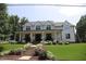 Charming two-story home with a well-maintained lawn, landscaped flower beds, and a welcoming covered front porch at 615 Sampson St, Raleigh, NC 27609