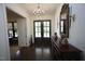 Elegant foyer featuring hardwood floors, chandelier lighting, decorative mirror, and double entry doors at 615 Sampson St, Raleigh, NC 27609