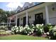Inviting front porch with classic white columns, black railings, and lush hydrangeas enhancing curb appeal at 615 Sampson St, Raleigh, NC 27609