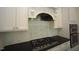 Modern kitchen featuring white subway tile backsplash, stainless steel appliances, and a gas range at 615 Sampson St, Raleigh, NC 27609