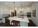 Spacious kitchen with white cabinets, quartz countertops, a center island, and stainless steel appliances at 615 Sampson St, Raleigh, NC 27609