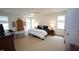 Spacious bedroom features neutral carpeting, bright natural light, and comfortable furnishings at 615 Sampson St, Raleigh, NC 27609