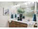 Well-lit bathroom with double vanity, framed mirrors, and stylish fixtures at 66 Renshaw Dr, Fuquay Varina, NC 27526