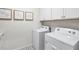 Well-equipped laundry room with white appliances, patterned floor, and ample space for laundry tasks at 66 Renshaw Dr, Fuquay Varina, NC 27526