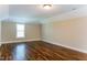 Versatile bonus room with hardwood floors, natural light, and neutral paint at 67 Bornean Dr, Garner, NC 27529
