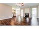 Open concept living room flowing into kitchen, featuring hardwood floors and a fireplace at 67 Bornean Dr, Garner, NC 27529