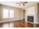 Cozy living room showcasing a fireplace, hardwood floors, and windows offering natural light at 67 Bornean Dr, Garner, NC 27529